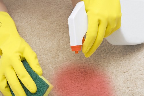 Cleaner in Richmond upon Thames using safety procedures during a professional cleaning task