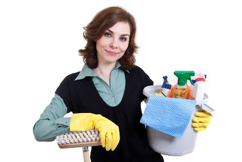 Cleaning staff wearing PPE while handling equipment safely in Richmond upon Thames